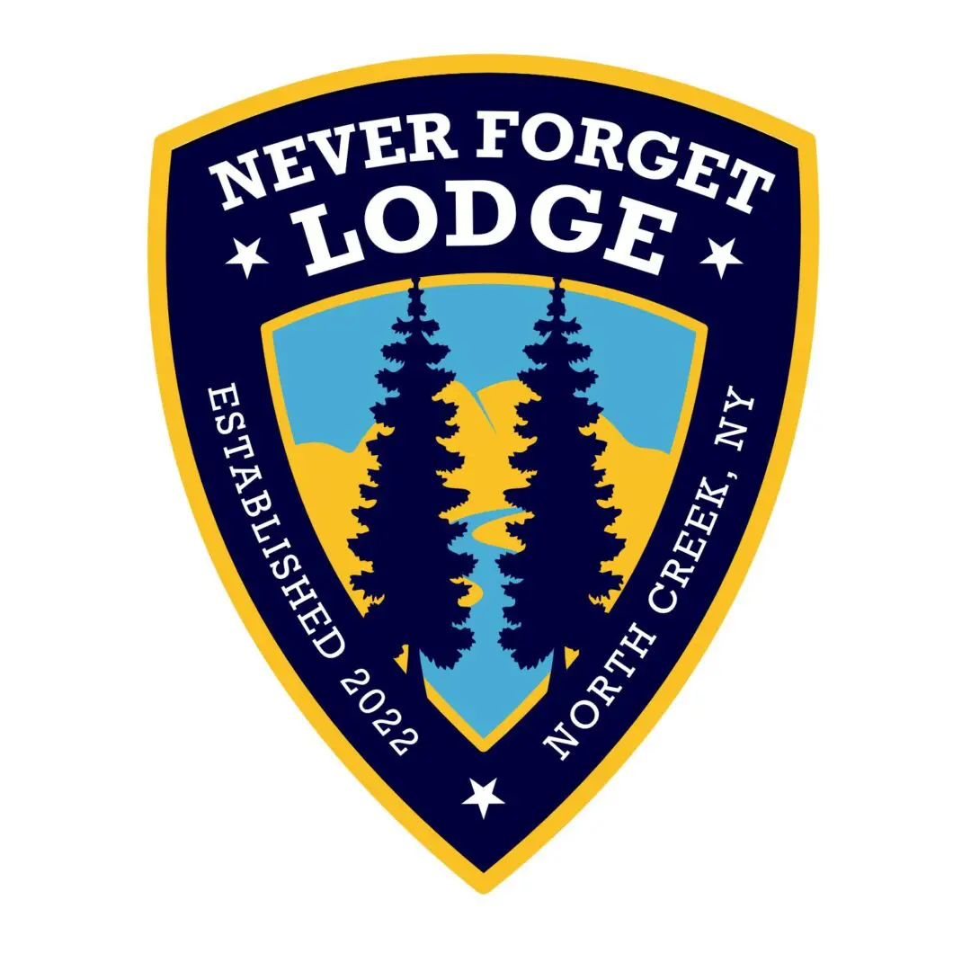 A badge with trees and the words " never forget lodge established 2 0 1 7 north creek, ny."